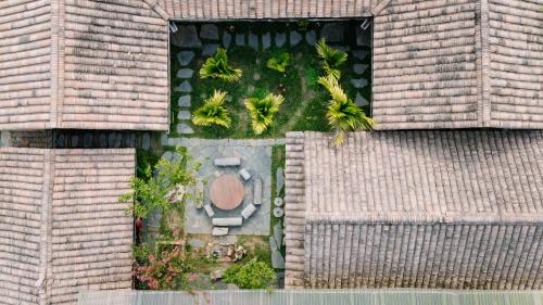 an overhead view of a garden with palm trees at Anans Home Ha Giang - Tours & Motorbike Rental in Ha Giang