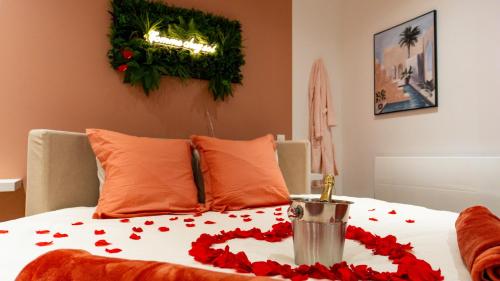 a bed with a bunch of red flowers on it at Comme chez soi - Amiens in Amiens