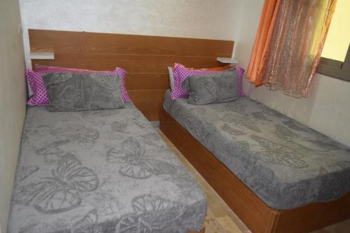 two beds in a small room withermottermottermott at hotel el amri akchour in Akchour