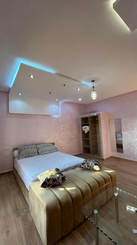 a bedroom with a large bed with blue lights at hotel diamond قصر الألماسة in Tan-Tan