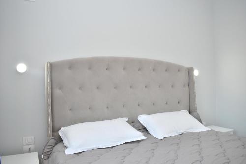 a bed with two white pillows on it at Wide Beach Apartments 236 in Mullini i Danit