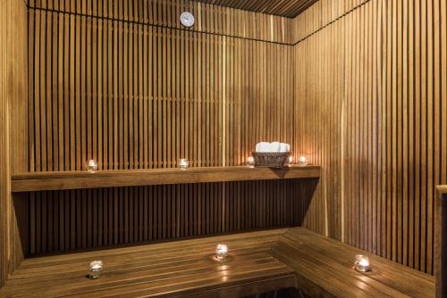 a wooden sauna with candles on a wooden shelf at NH Collection Bogota Andino Royal in Bogotá