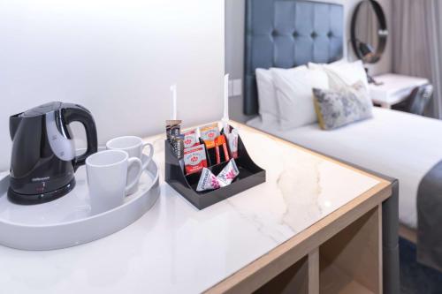 a coffee maker on a table in a hotel room at StayEasy Cape Town City Bowl in Cape Town