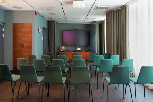 a conference room with chairs and a projection screen at Best Western Plus Hotel Noble House in Malmö