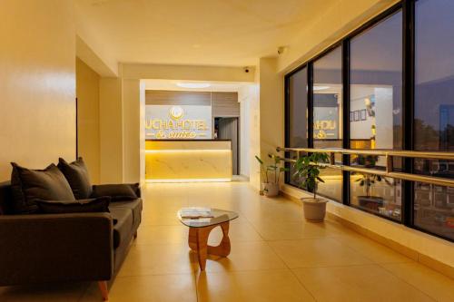 a living room with a couch and a table at Ucha Hotel & Suites in Kampala