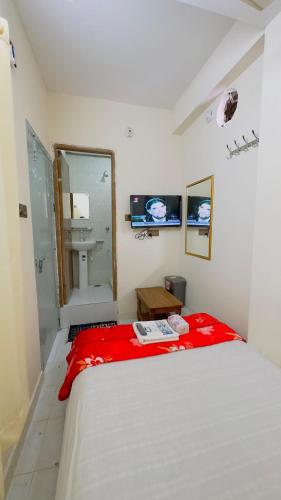 a white bedroom with a bed and a shower at Hotel New Kalabgan Residential in Dhaka