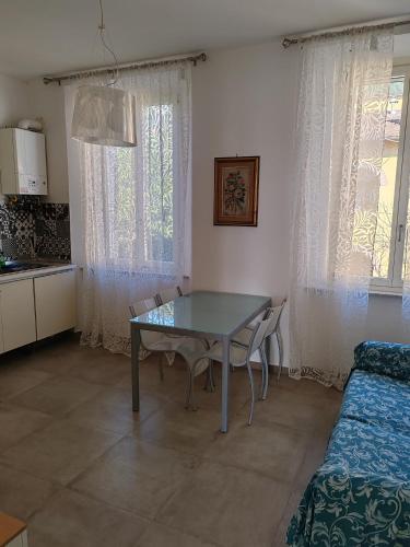 a dining room with a table and chairs and a bed at Valle delle fonti in Asciano Pisano
