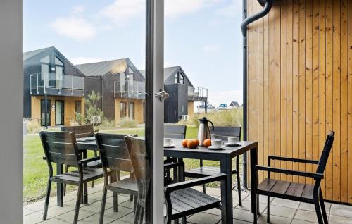 a patio with a table and chairs on a balcony at Kysthusene, Lejl 19 in Slagelse