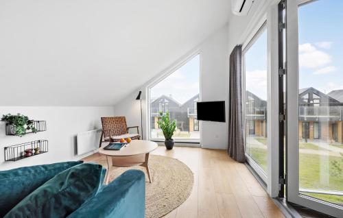 a living room with a couch and a table at Kysthusene, Lejl 19 in Slagelse