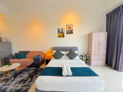 a bedroom with a large bed and a couch at 3 Towers Jalan Ampang By Serenity Vacation Homes in Kuala Lumpur
