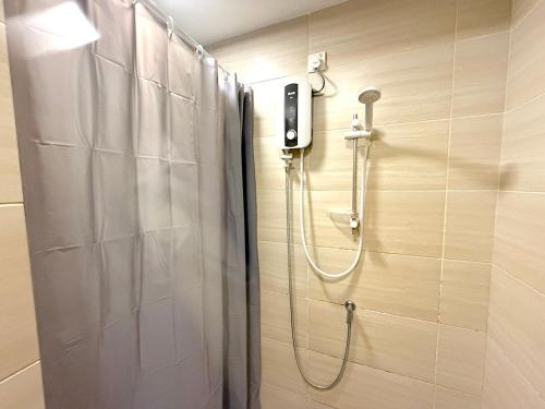 a shower in a bathroom with a phone on the wall at 3 Towers Jalan Ampang By Serenity Vacation Homes in Kuala Lumpur