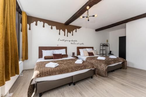 two beds in a room with two beds sidx sidx sidx sidx at The Chocolate Suites in Bruges