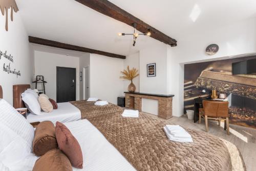 two beds in a room with a fireplace at The Chocolate Suites in Bruges