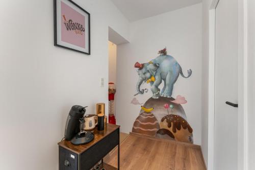 a room with a desk with a statue of an elephant at The Chocolate Suites in Bruges