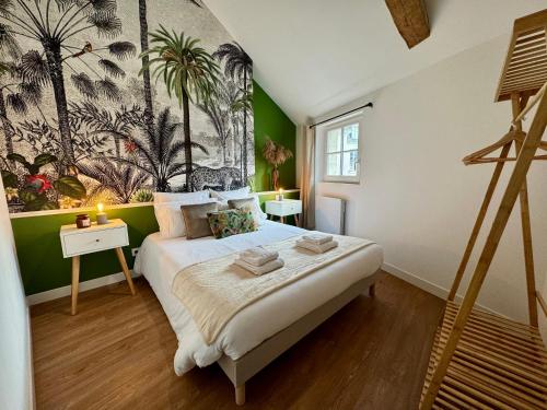 une chambre avec un grand lit avec un tableau au mur dans l'établissement Appartement centre ville climatisé vue Château, à Saumur