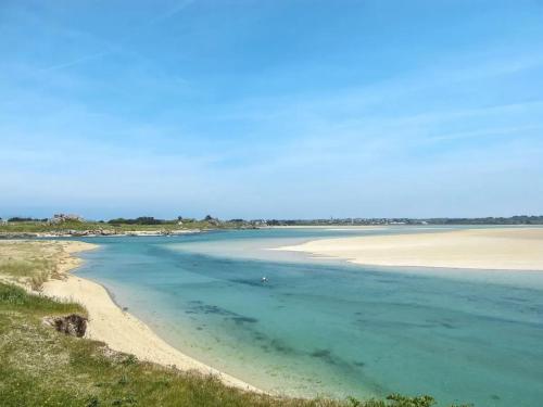 a view of a beach with the sand and water at Maison cosy à Plouescat avec jardin et terrasse in Plouescat