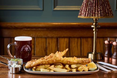 a plate of fish and french fries and a glass of beer at Hotel Victoria in Whitby