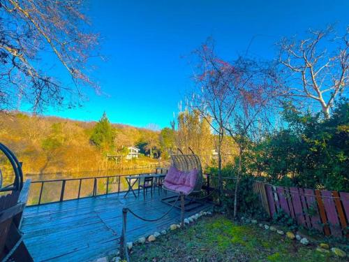 a deck with a table and a chair on it at Paradise Plus Ağva in Agva