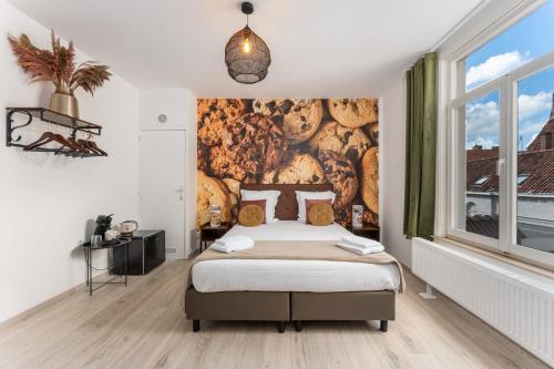 a bedroom with a bed and a wall mural at The Chocolate Suites in Bruges