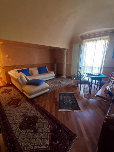 a living room with a couch and a table at Maison Platone Prestige in Alessandria