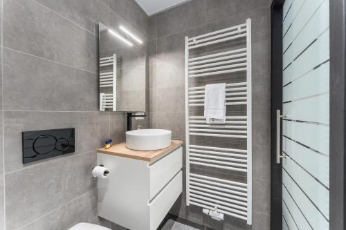 a bathroom with a sink and a toilet in it at The Chocolate Suites in Bruges