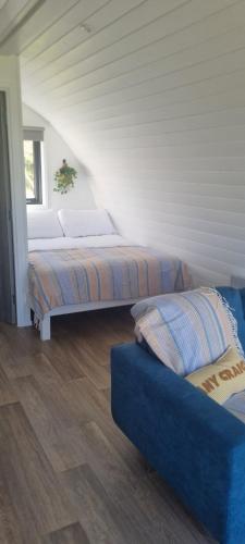 a room with two beds and a couch in it at Coastal Hideaway Pod in Fisherstreet