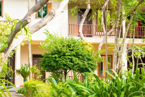 a building with trees and plants in front of it at NIKARA Luxury Beach House in Tissamaharama