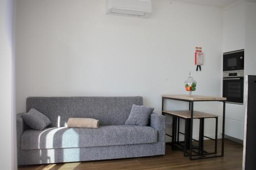 a living room with a couch and a table at Like Home I - vista mar e ambiente relaxante in Funchal