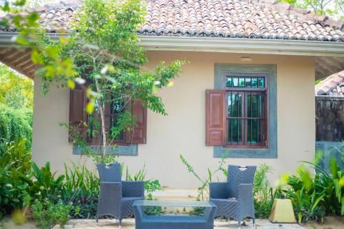 a house with chairs and a table in front of it at NIKARA Luxury Beach House in Tissamaharama