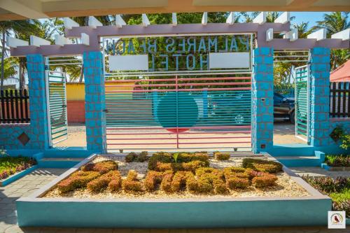 a garden in front of a building with a bench at Palmares Beach Hotel in Andjamen
