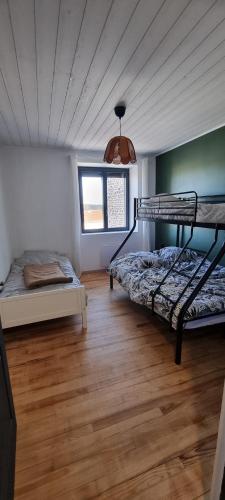 a bedroom with two bunk beds in a room at Gîte de la fontaine in Issanlas