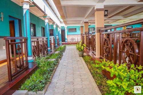 a corridor of a building with plants and a walkway at Palmares Beach Hotel in Andjamen