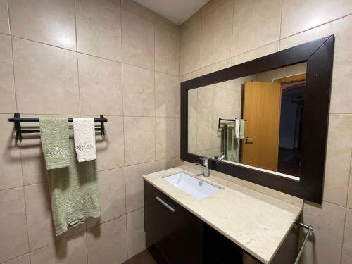 a bathroom with a sink and a mirror at Retiro das Águas - Gerês in Terras de Bouro