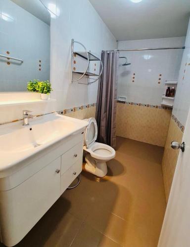 a bathroom with a sink and a toilet and a shower at Perfect Home 15 mins from airport in Chiang Mai