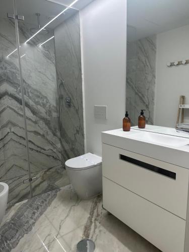 a bathroom with a toilet and a sink and a shower at Porto Neptune Terrace in Vila Nova de Gaia