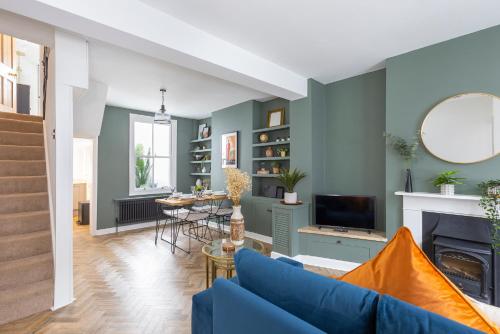 a living room with a blue couch and a fireplace at Queens Gardens in Brighton & Hove