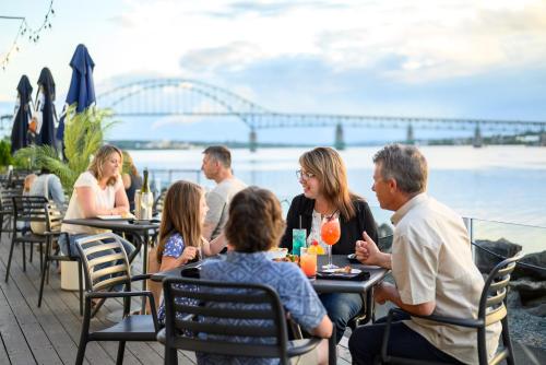 a group of people sitting at tables at a restaurant at Rodd Miramichi in Miramichi