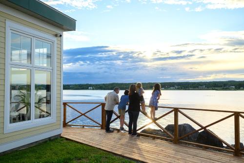 a family standing on the porch of a house at Rodd Miramichi in Miramichi