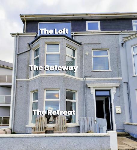 a building with a sign that reads the loft the cafeteria at The Loft Guest Apartment in Portstewart