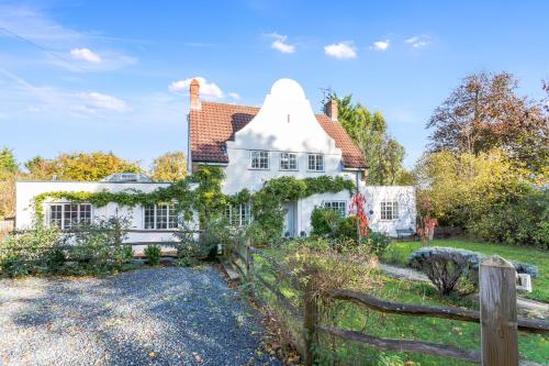 a white house with a fence in front of it at Pretty Country Home Dog Friendly On Request in Henfield