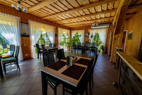 a dining room with tables and chairs and christmas trees at Imantas nams in Jūrkalne