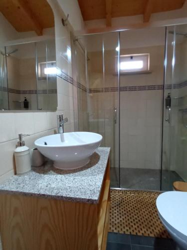 a bathroom with a sink and a shower at Casa do Moinho Rural Retreat in Podentes
