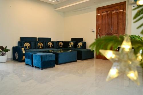 a living room with a blue couch and a star at LeafyInn Premium 2BHK Apartment-Khanapara in Guwahati