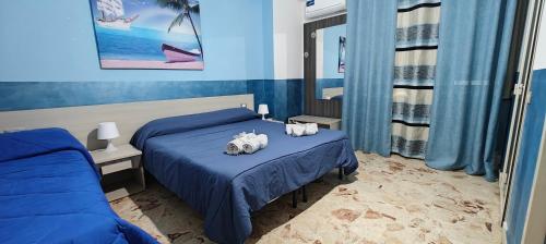 Postel nebo postele na pokoji v ubytování Nettuno Rooms