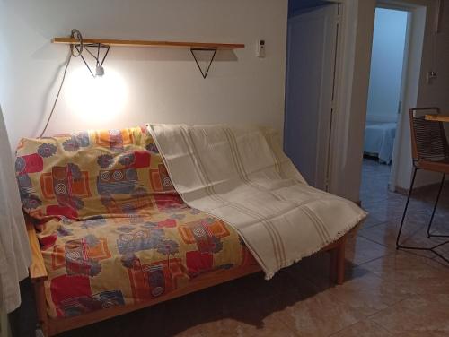 une chambre avec un lit avec une couverture dessus dans l'établissement Departamento Parque Norte, à San Rafael
