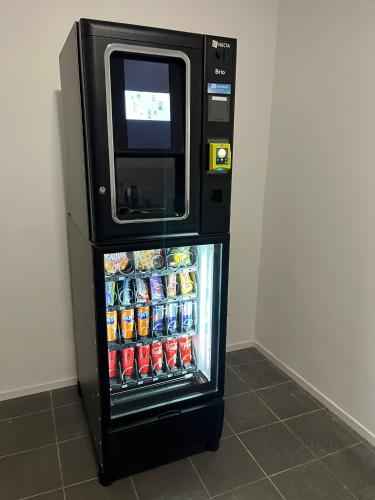 a refrigerator with a microwave on top of it at Charleville C centre - gare - aéroport in Charleroi
