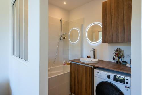 une salle de bain avec une machine à laver et un lavabo dans l'établissement Lumineux et cosy T2 en centre ville, à Aix-en-Provence