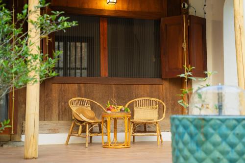 a table and chairs in front of a building at Charm Vân Long in Ninh Binh