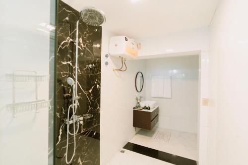 a bathroom with a shower and a sink at Charm Vân Long in Ninh Binh