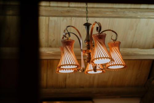 a group of four lights hanging from a ceiling at Charm Vân Long in Ninh Binh
